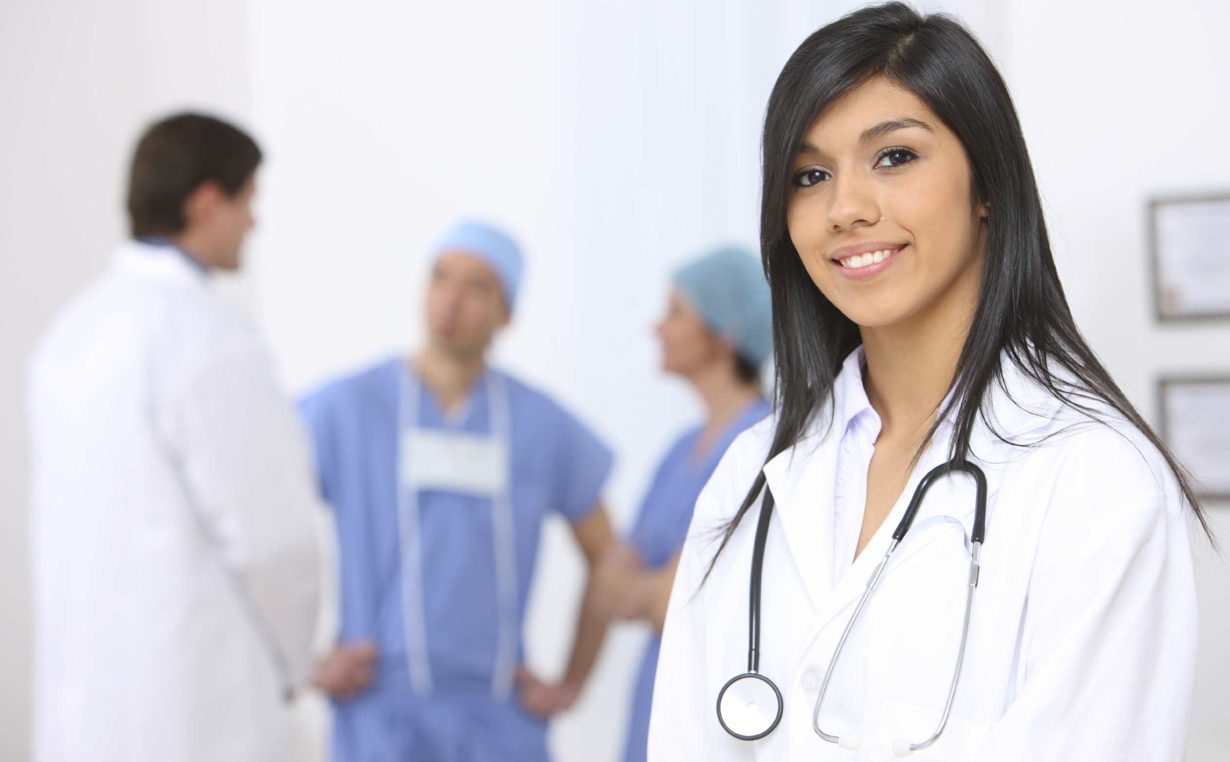 smiling_medical_doctor_with_stethoscope_on_the_hospitals_background_1350367266